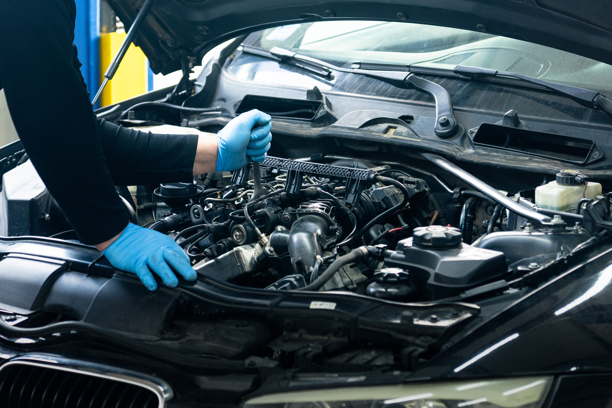 mechanic working on a engine of a European car
